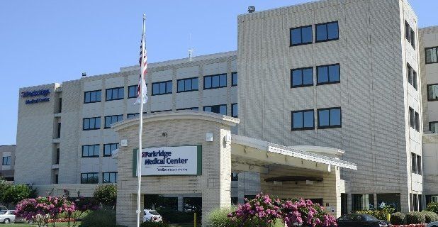 A large building with a flag in front of it
