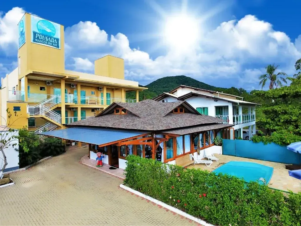 Um grande hotel com uma piscina na frente-Pousada-Nascer do Sol