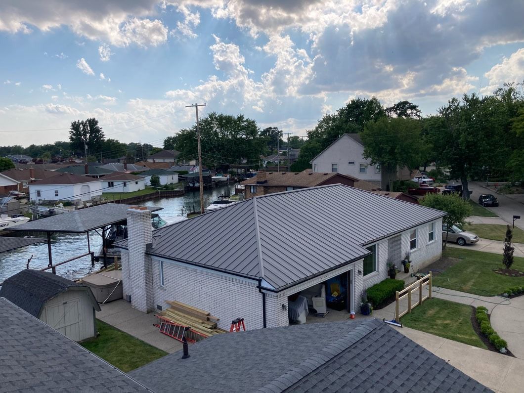 Houses with a canal and docks under a cloudy sky.
