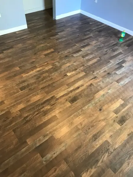 Wood floor with various shades of brown and gray planks.
