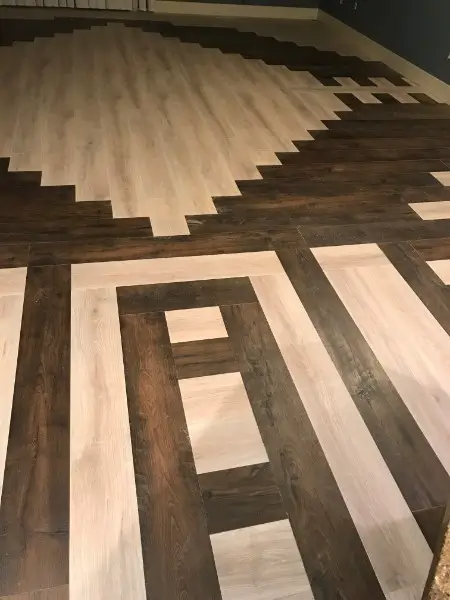 Geometric wood-look tile floor in alternating light and dark brown, with a large diamond pattern.