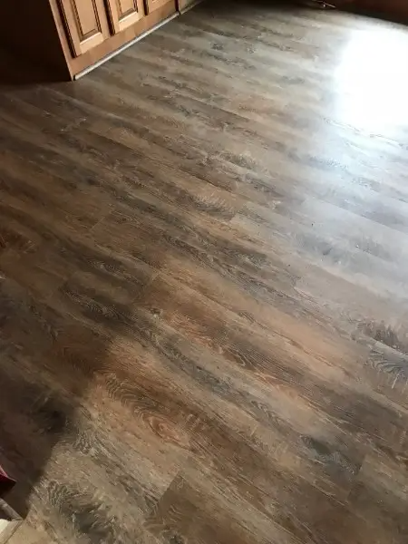 Wooden floorboards, varying shades of brown, in a room.