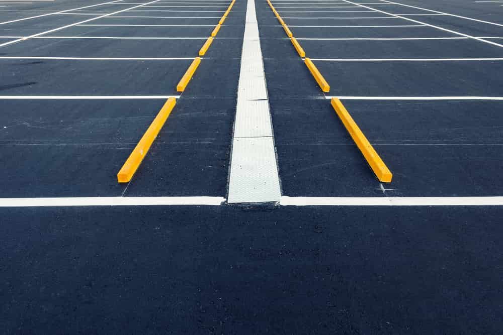 A Parking Lot With Yellow And White Lines On It — Territory Bitumen Services In Tivendale, NT