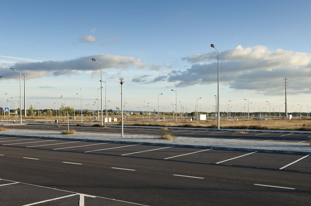 An Empty Parking Lot With A Blue Sky In The Background — Territory Bitumen Services In Tivendale, NT