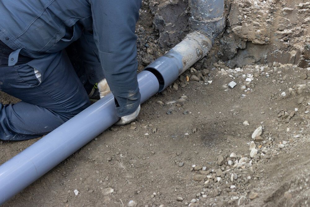 Person Connecting Two Gray PVC — Cliff Tucker Plumbing In Emerald, QLD