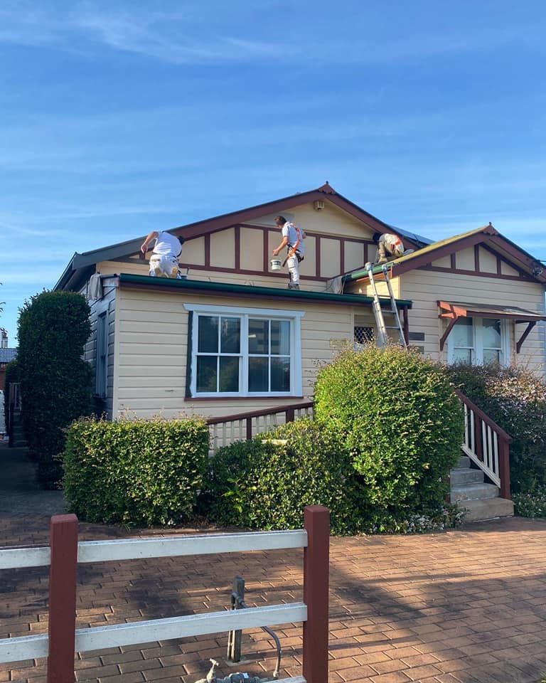 Men Painting the Roof of a Beige House With Brown Trim — S D Maintenance In Gosford, NSW