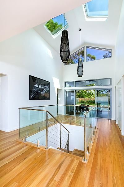Bright Interior With Wood Floors, Glass Railings, Skylights, and Outdoor View — S D Maintenance In Point Clare, NSW