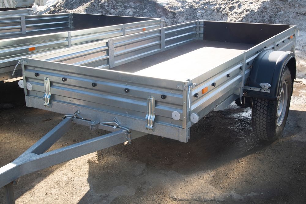 Silver Utility Trailer Parked on Dirt, with Metal Sides — Connect Trailers and Towing Pty Ltd In Prospect Vale, TAS 