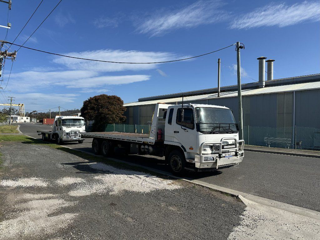 White Flatbed Truck Parked on A Gravel — Connect Trailers and Towing Pty Ltd In Prospect Vale, TAS 