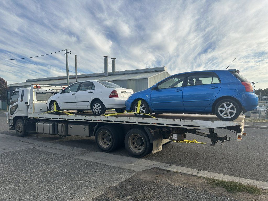 Damaged Cars Strapped on a Flatbed Tow Truck — Connect Trailers and Towing Pty Ltd In Prospect Vale, TAS