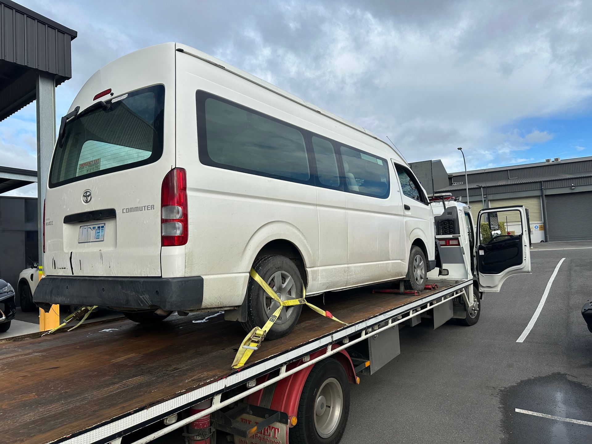 White Van Secured on A Flatbed Tow Truck with Straps — Connect Trailers and Towing Pty Ltd In Prospect Vale, TAS