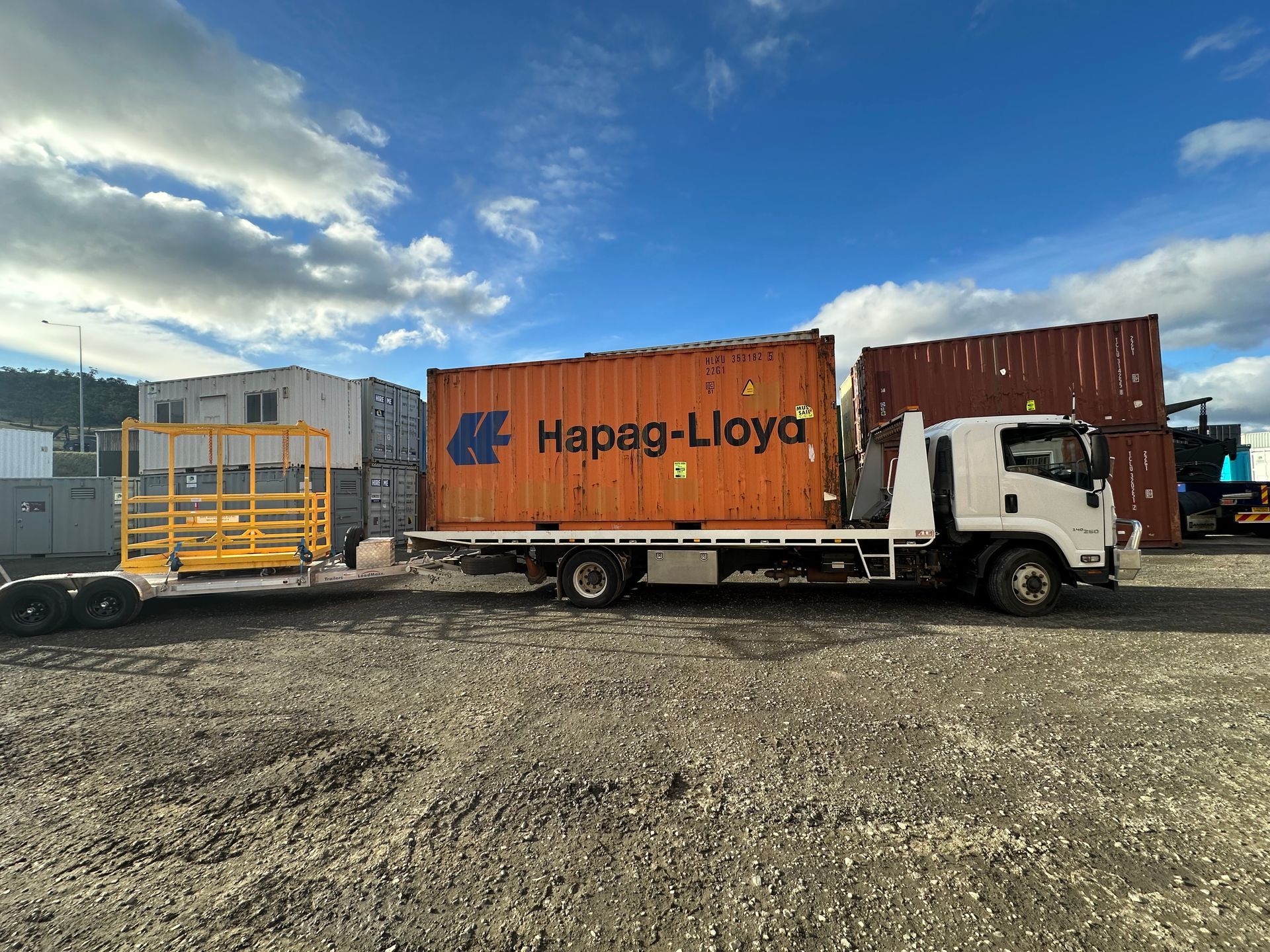 White Flatbed Truck with A  Container Parked on A Gravel — Connect Trailers and Towing Pty Ltd In Prospect Vale, TAS 