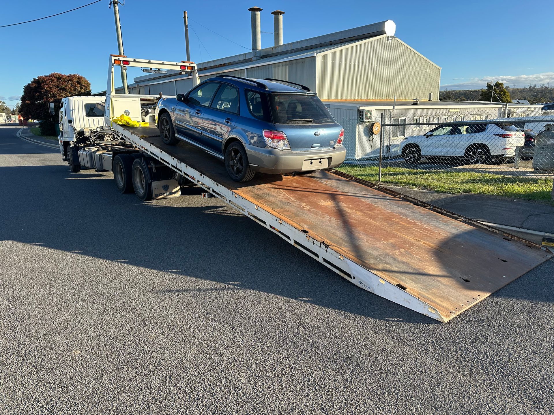 Blue SUV on a Tow Truck Ramp — Connect Trailers and Towing Pty Ltd In Prospect Vale, TAS 