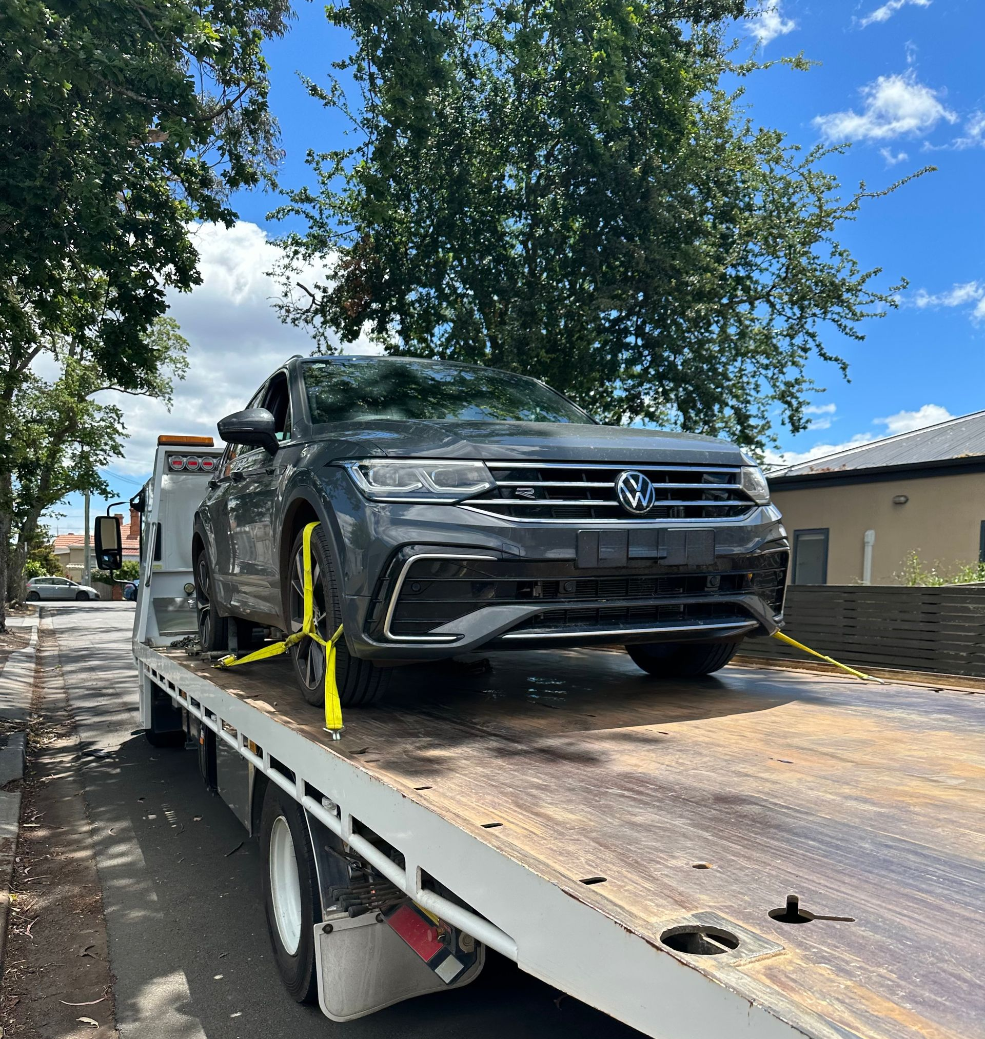 SUV Secured on A Flatbed Tow Truck on A Street — Connect Trailers and Towing Pty Ltd In Prospect Vale, TAS 
