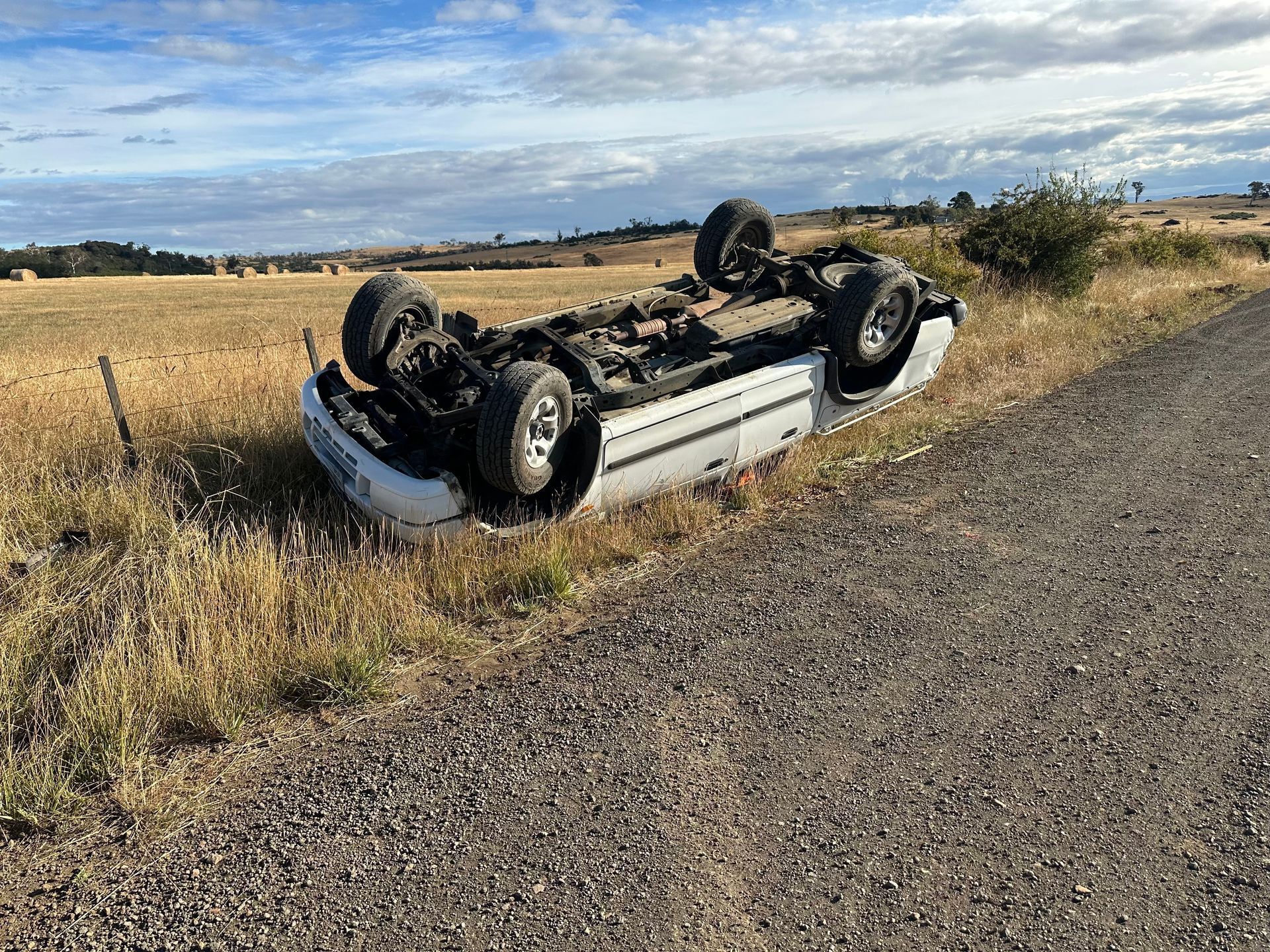 Overturned White Car in Roadside Ditch — Connect Trailers and Towing Pty Ltd In Prospect Vale, TAS 