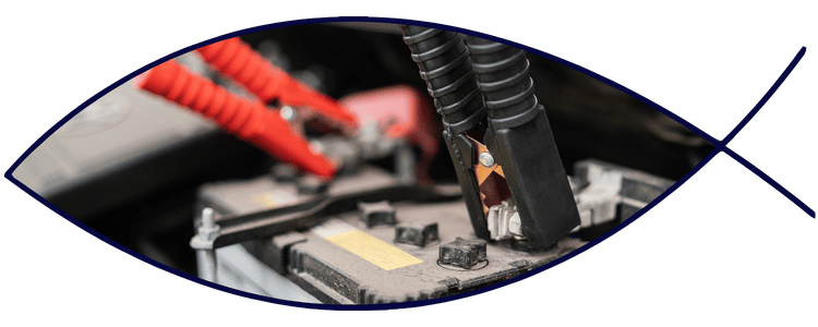 Car battery with jumper cables attached for service