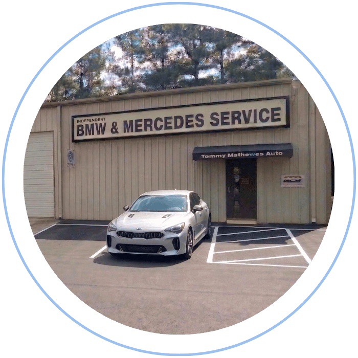 Kia sedan parked in front of Tommy Mathewes Auto Repair