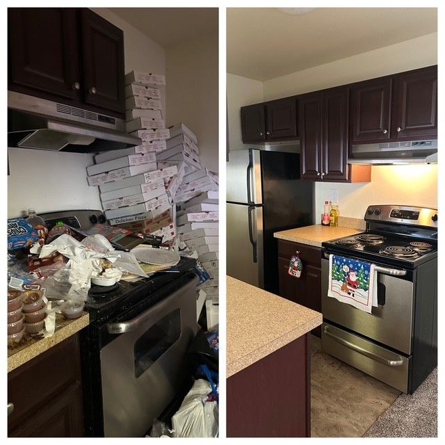Cluttered kitchen with stacked pizza boxes by the stove on the left, tidy stove and stainless fridge on the right.