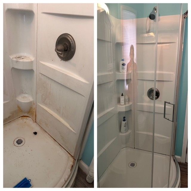 Small white shower stall with shelf, round wall vent, and glass door in a compact bathroom.