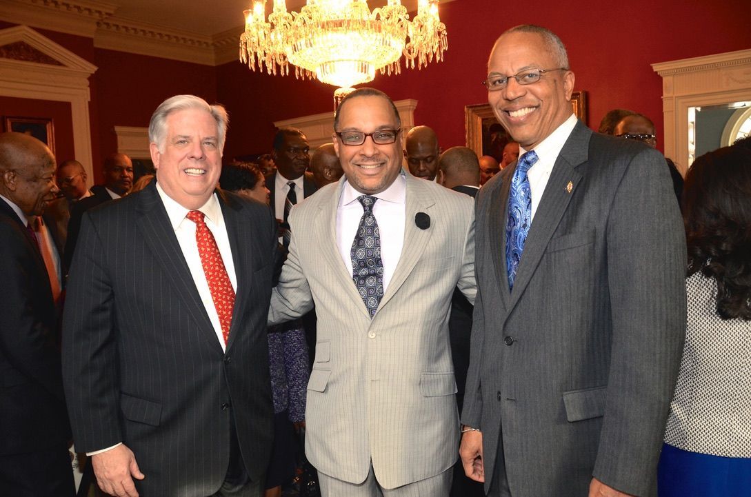 Three men in suits and ties are posing for a picture.