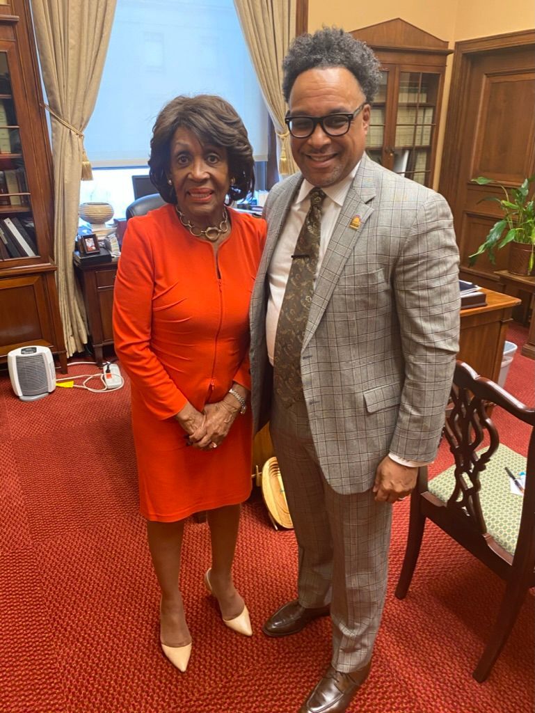 A man and a woman are standing next to each other in a room.