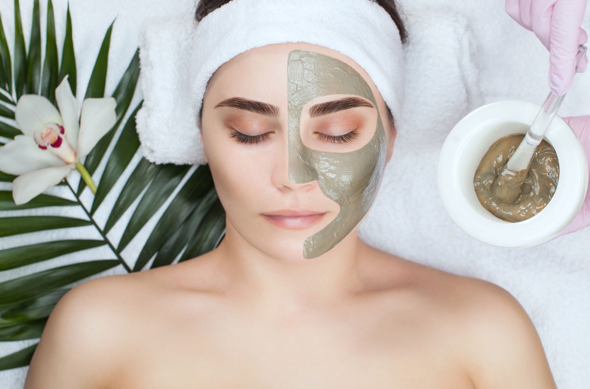 beautiful woman with clay mask applied to the face