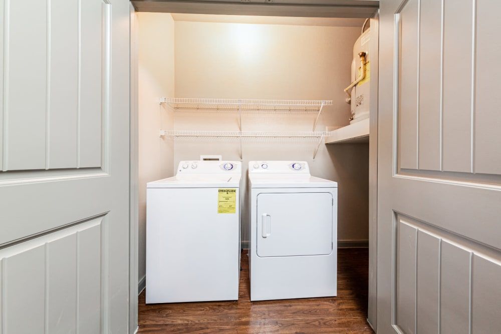 a laundry room with a washer and dryer in it at Marquis at Katy in Katy, TX.