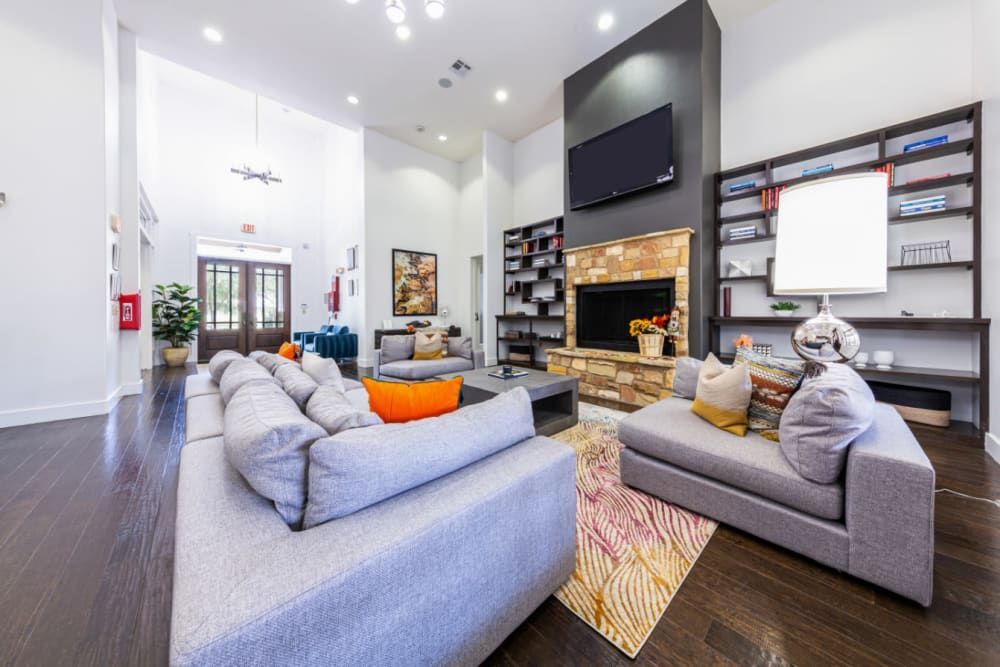 a room filled with furniture and a fireplace at Marquis at Katy in Katy, TX.