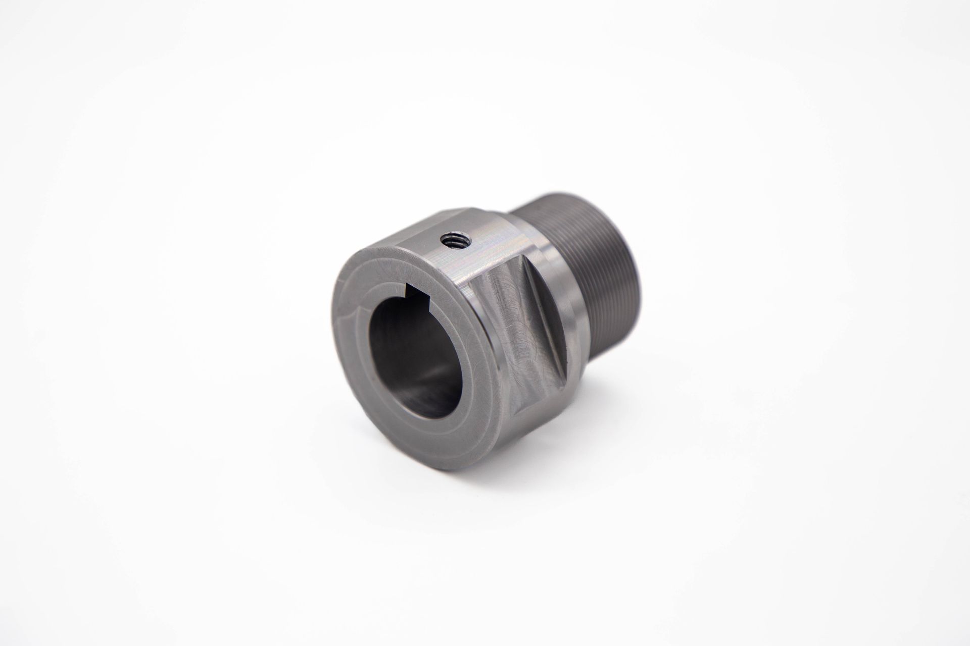 A metal shaft coupling with a keyway and set screw, on a white background.