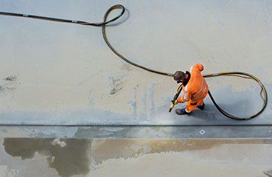 Man Sandblasting Concrete Surface — Linn Grove, IA — Hare Painting & Sandblasting Man Sandblasting Concrete Surface — Linn Grove, IA — Hare Painting & Sandblasting