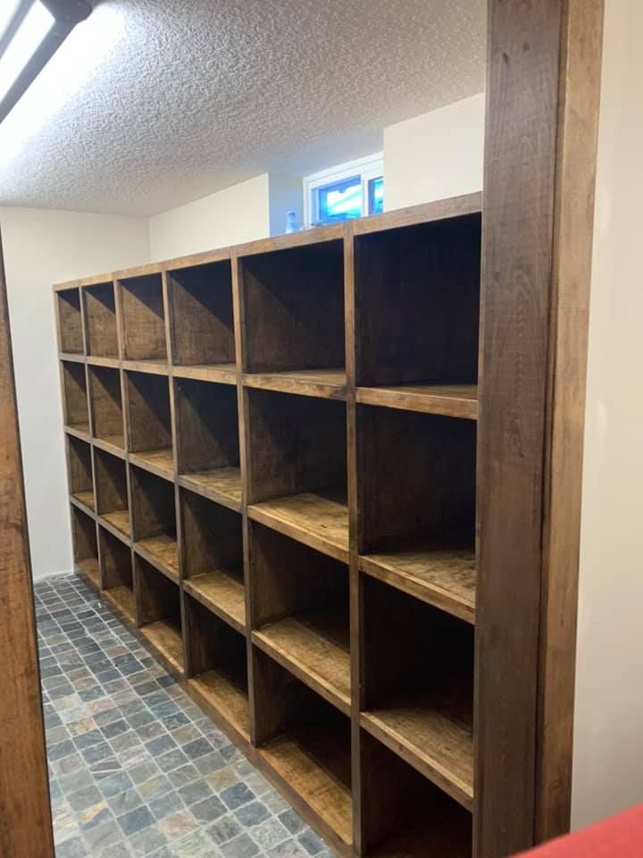 A row of wooden shelves in a room with a tiled floor.
