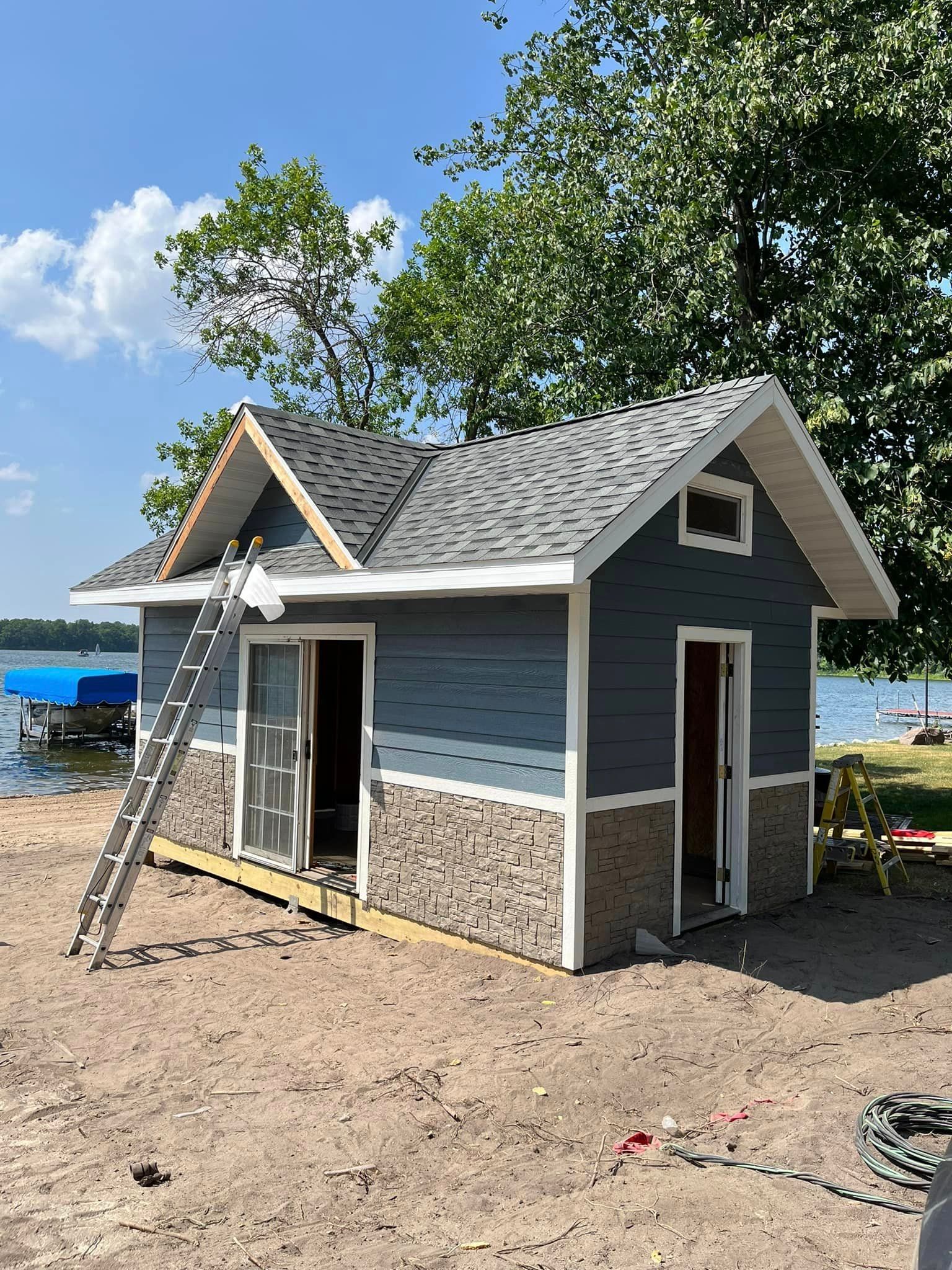 A small house is being built on the shore of a lake.