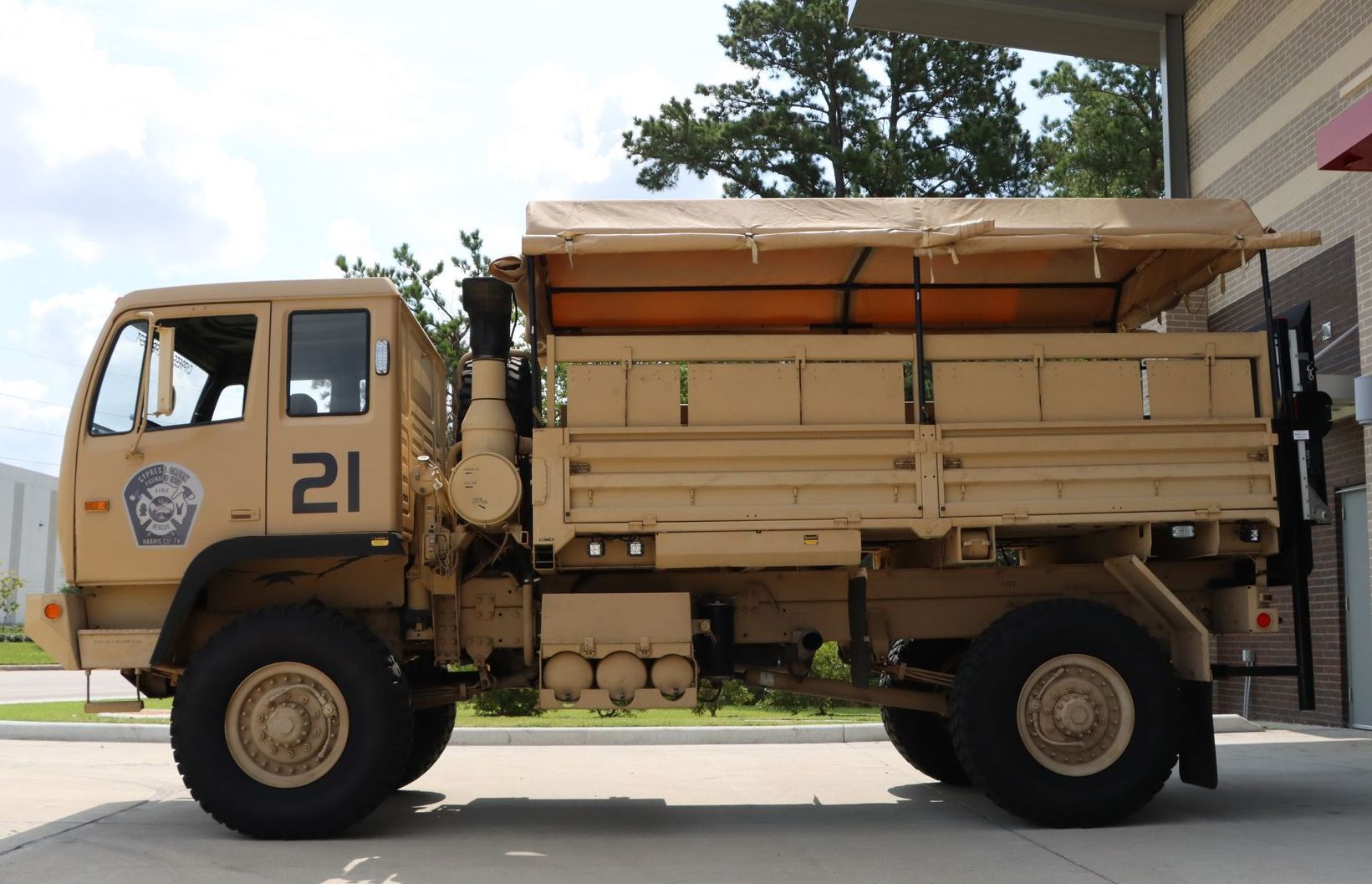 A military truck with the number 21 on the side. Cypress Creek Heavy Utility Truck 21