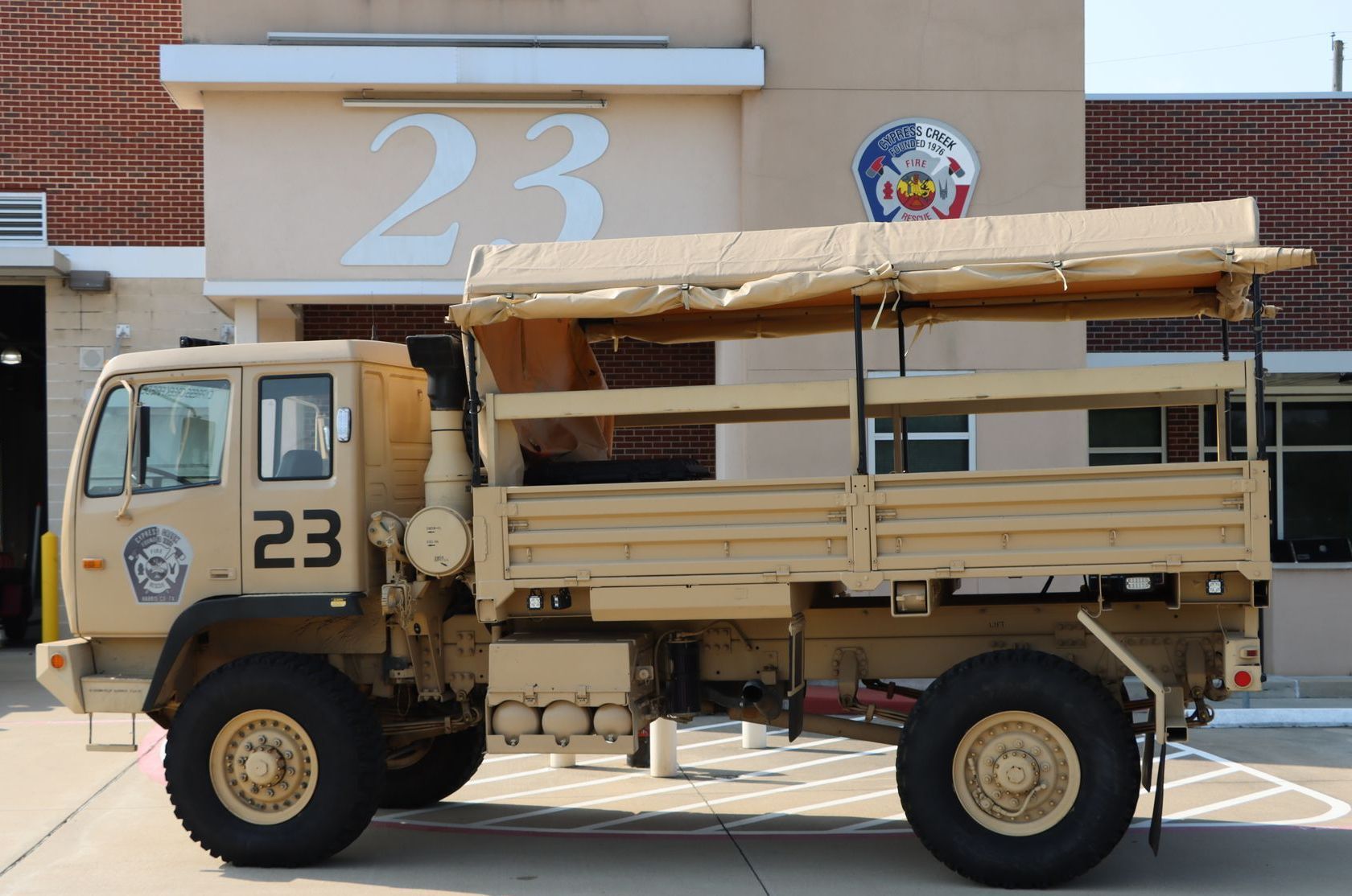A military truck with the number 23 on the side. Cypress Creek Heavy Utility Truck 23.