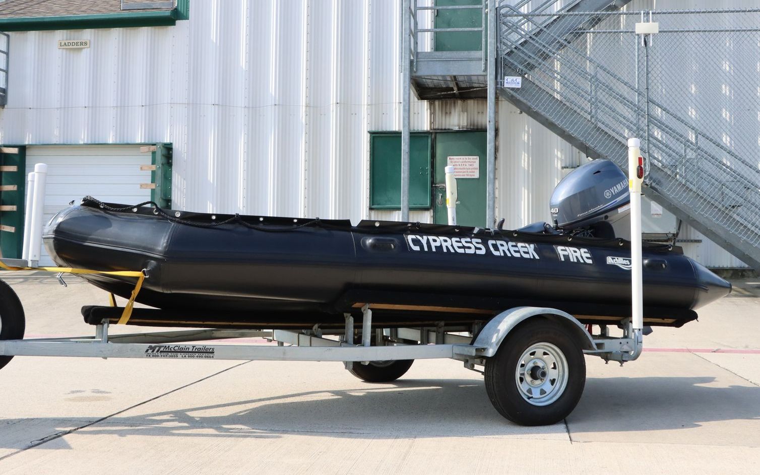 A boat on a trailer that says cypress creek on it. Cypress Creek Rescue boat 24.