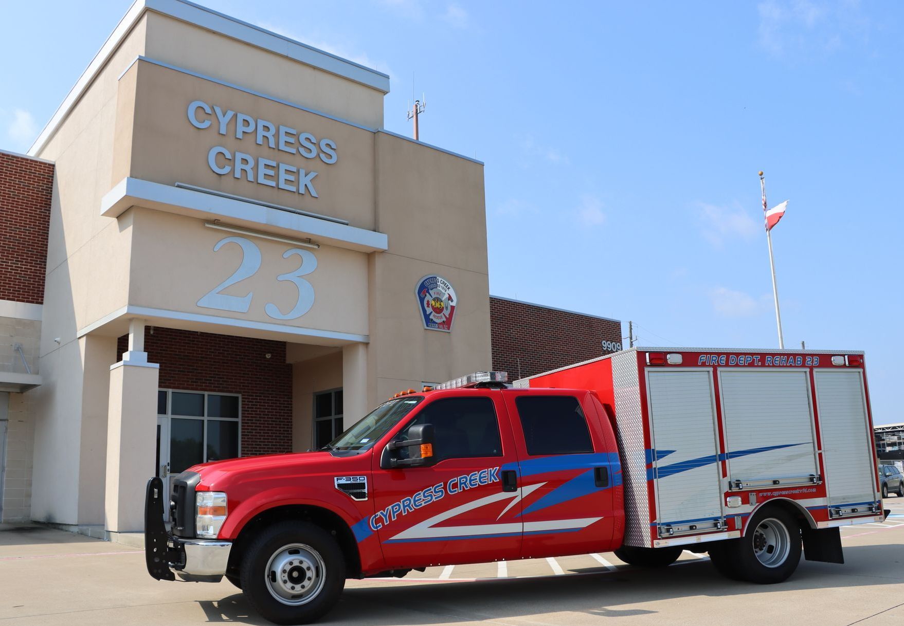 A red fire truck is parked in front of the cypress creek fire station. Cypress Creek Rehab 23.
