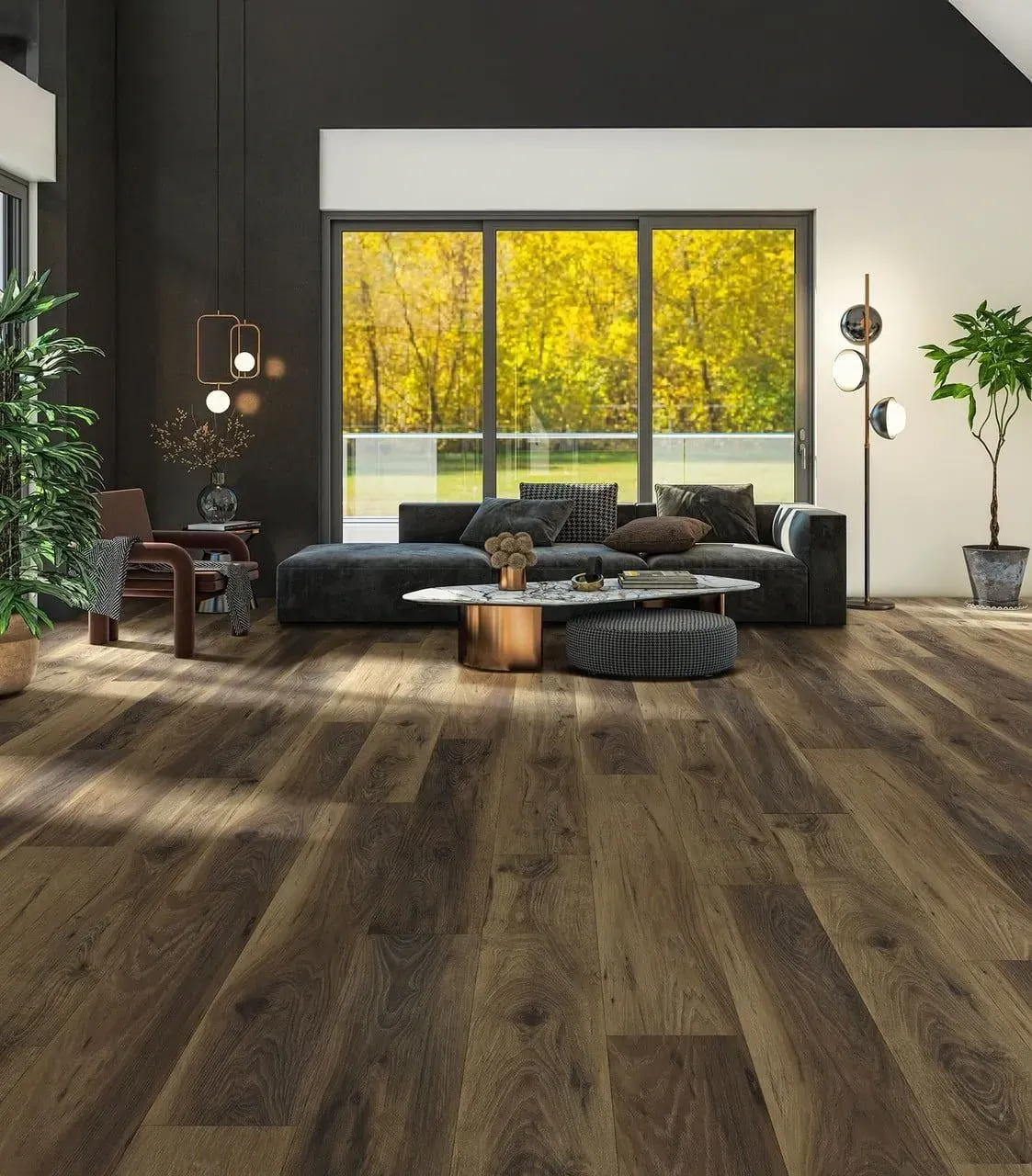 Modern living room with dark sofa, wood flooring, and large windows