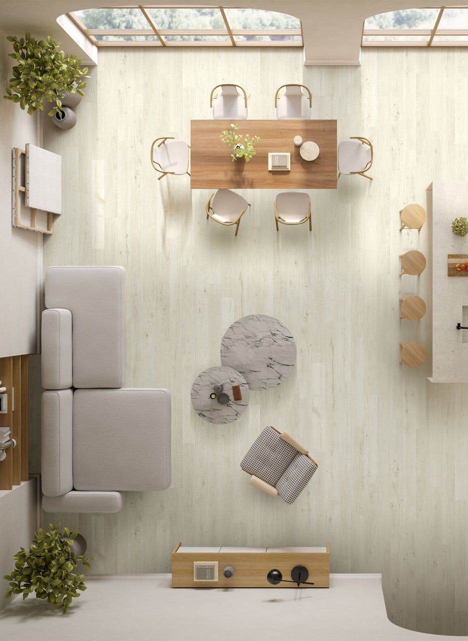 Modern white kitchen with wooden countertops, gray flooring, two windows, and hanging pendant lights over a small table.