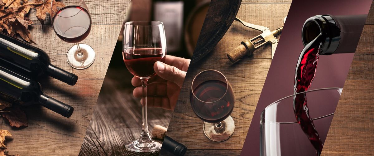 Red wine bottles, glasses, a corkscrew and a pour of red wine on rustic wood