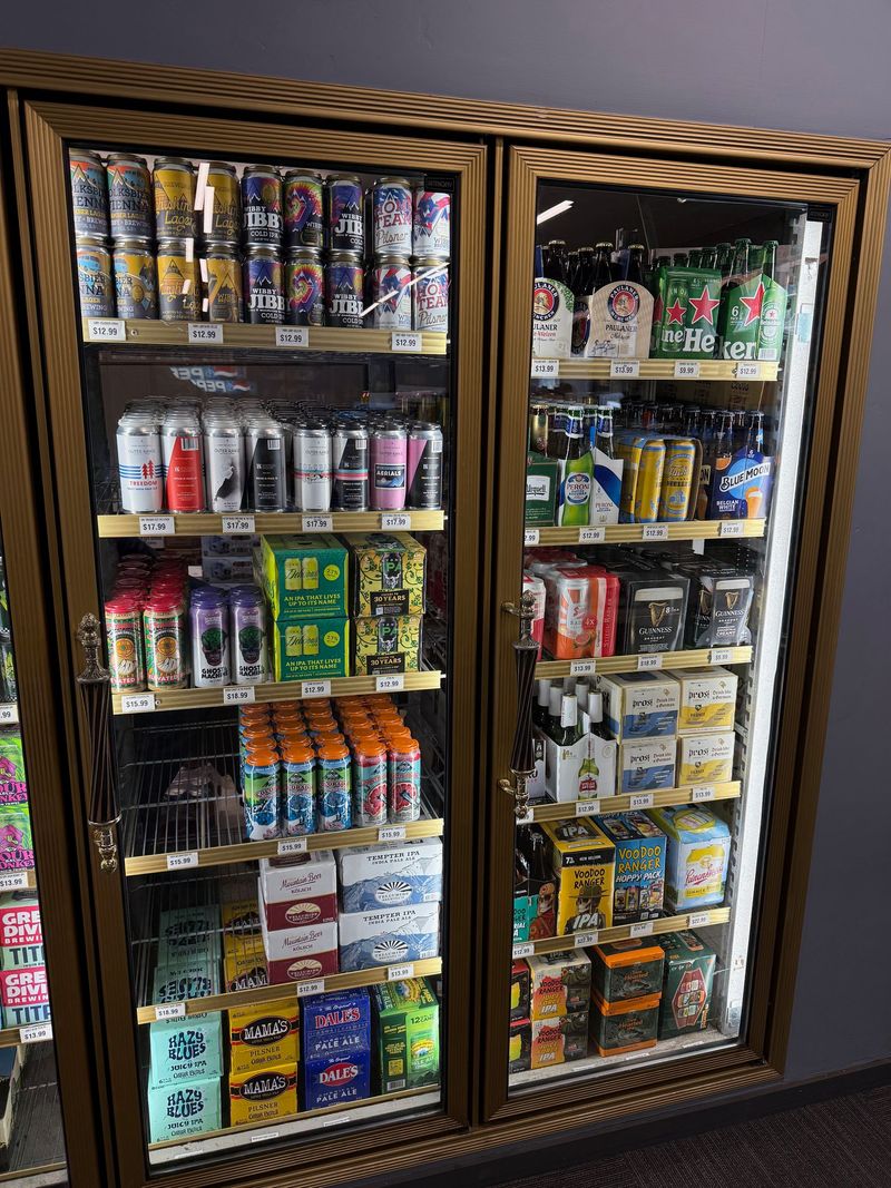 Cooler doors stocked with Colorado craft beer cans and imported bottles