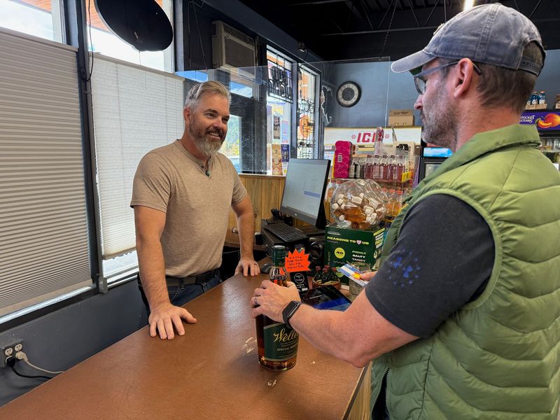 A Pier 13 team member helping a customer at the counter
