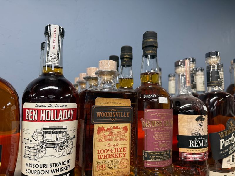 Bourbon and rye whiskey bottles including Ben Holladay and Woodinville