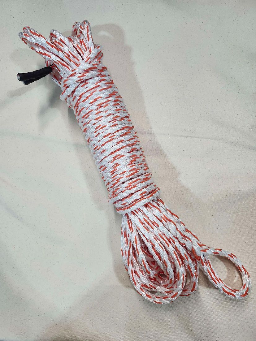 A coil of white rope with thin orange speckles, showing a loop at one end and a small black tab at the other.