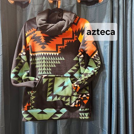 A black fleece hoodie with a cowl neck, featuring a geometric Southwestern-style print in orange and turquoise.