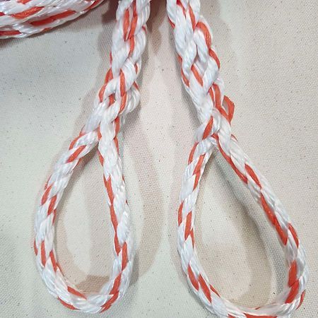 Two loops of twisted white and orange rope hanging against a light, textured background.