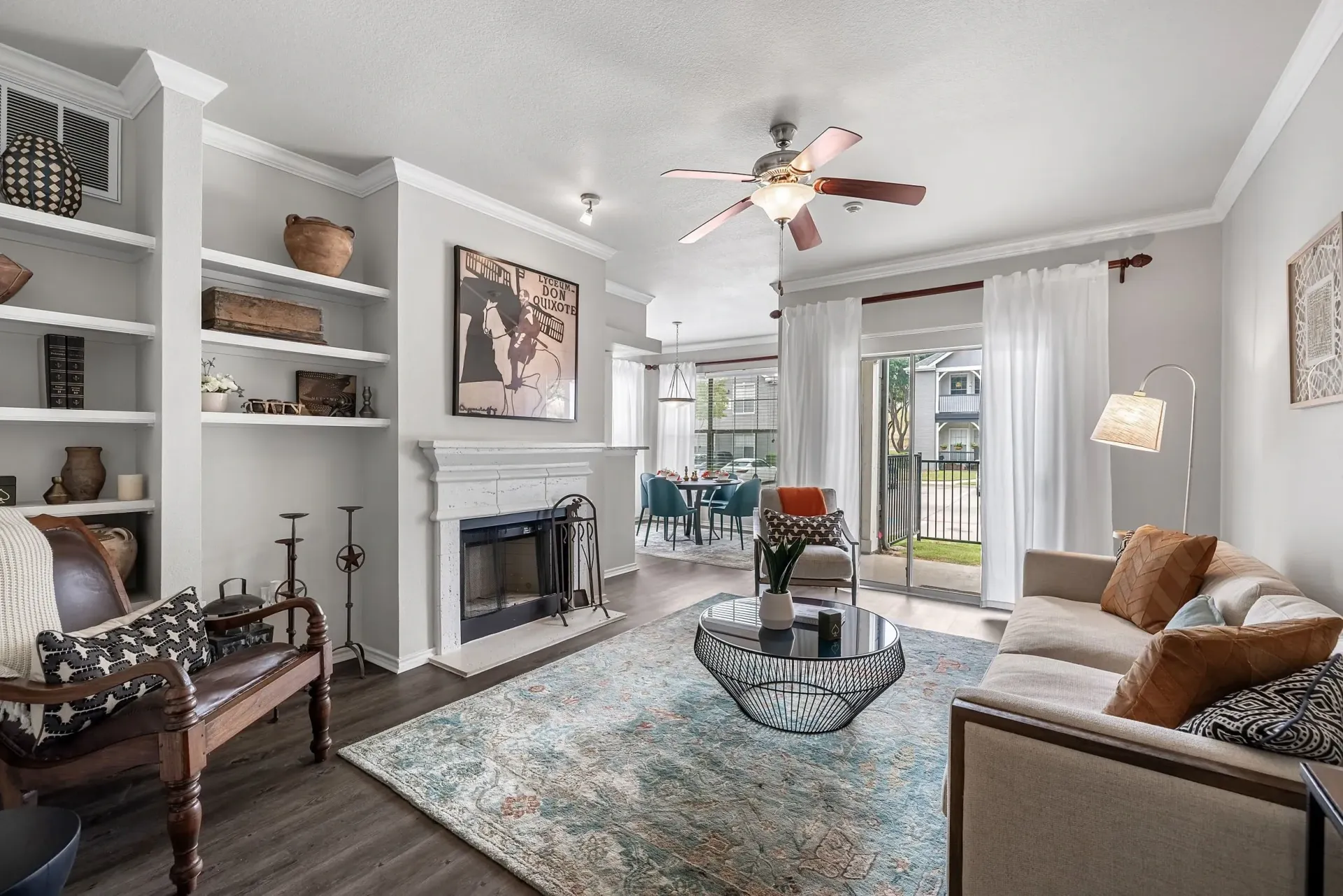 Living room with fireplace, built-in shelves, and sofa.