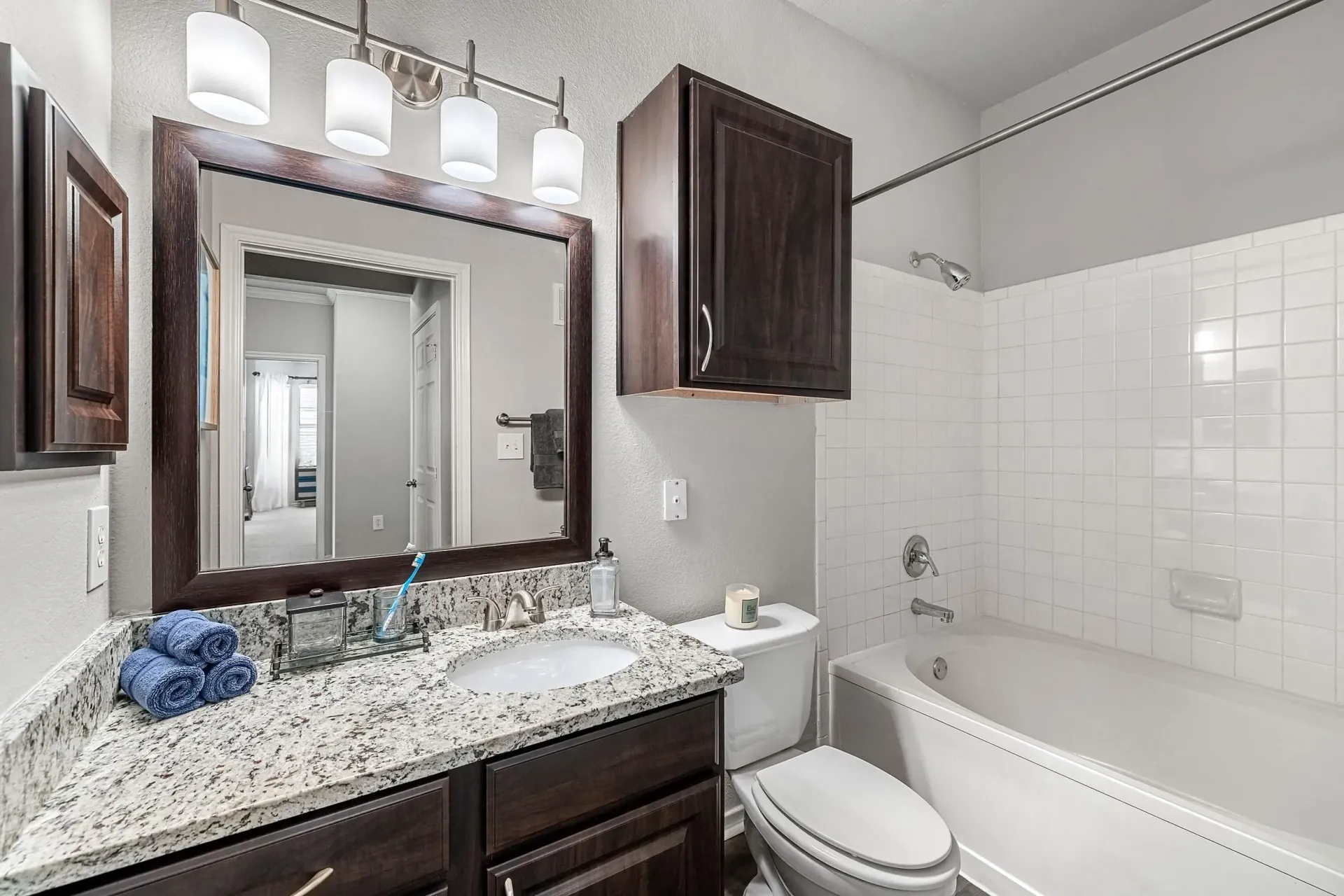 Bathroom with vanity, toilet, and bathtub.