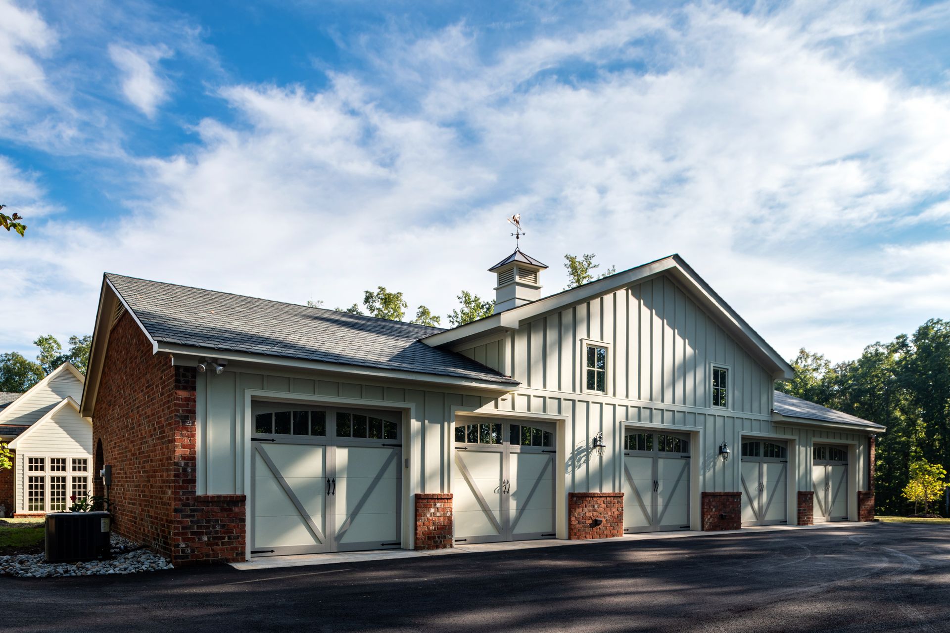 a garage with a weather vane on top of it
