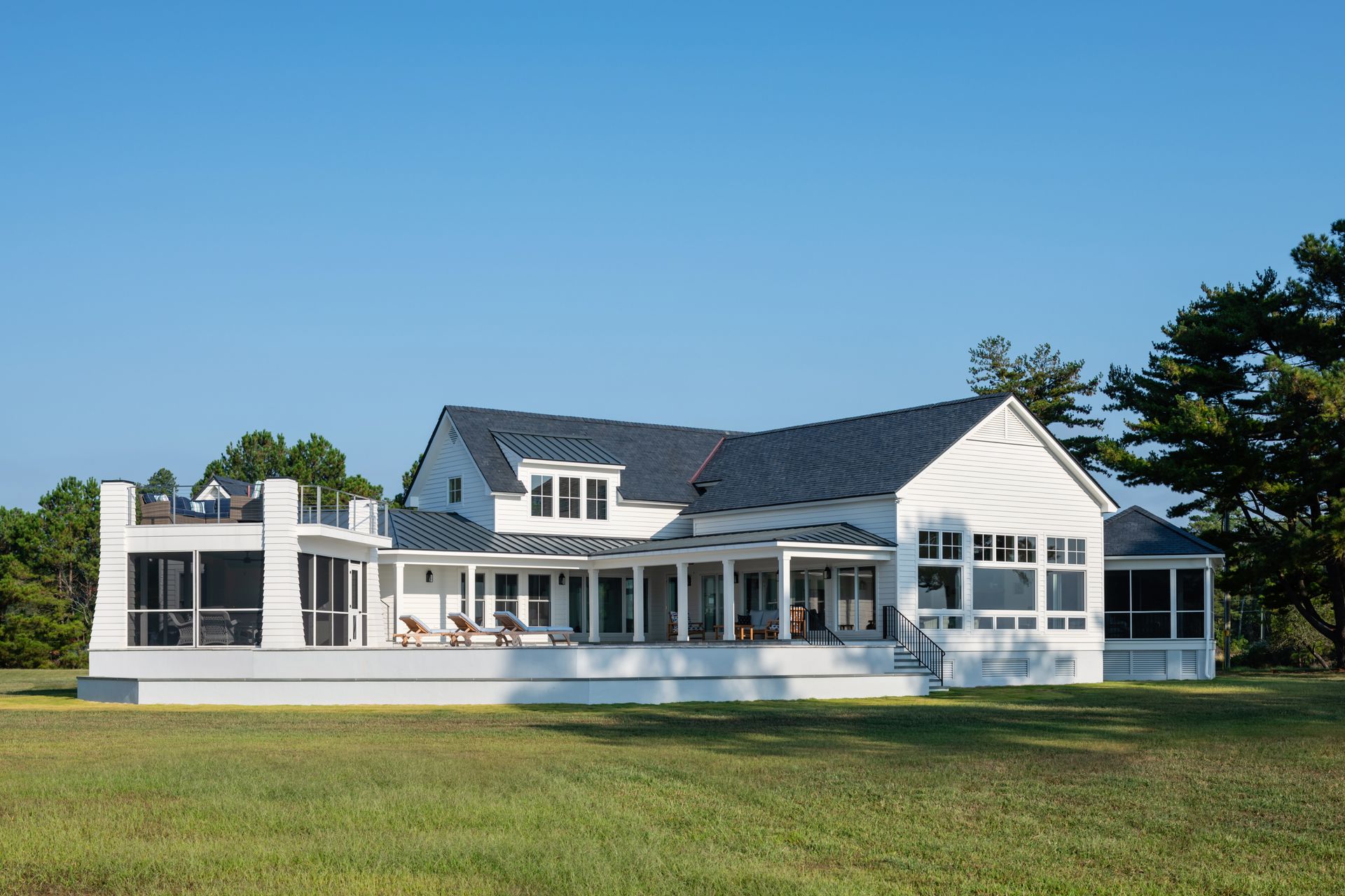 a large white house with a screened in porch
