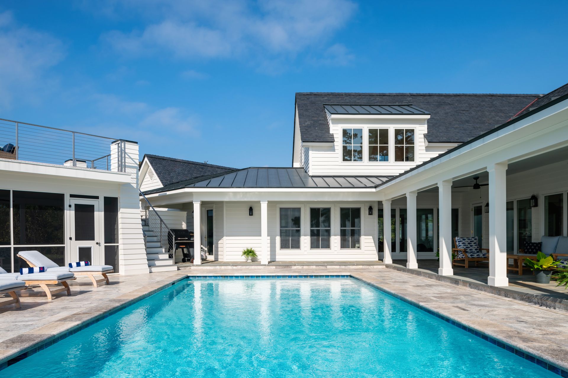 a white house with a large swimming pool in front of it